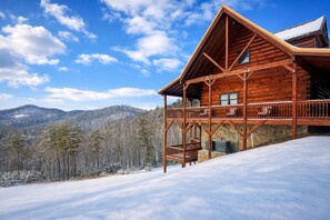 A wooden cabin with a balcony, set against a snowy landscape with mountains in the background. - Private Mountain Escape for Large Groups Sleeps 17 (Dobson)