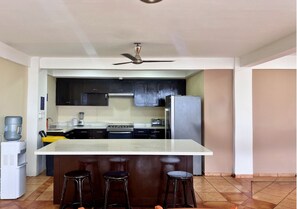 Full-size fridge, dishwasher, cookware/dishes/utensils, paper towels