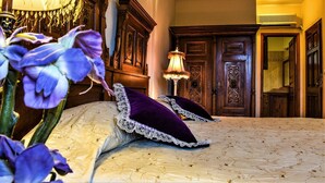 A bedroom with a large bed, ornate wooden furniture, and a decorative lamp. - Archontiko Polyzos 11 Manolia (Volos)