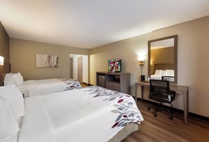 A hotel room with two beds, a desk, a chair, a television, and a mirror. - Red Roof Inn Painted Post (Painted Post)