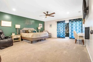 A bedroom with a bed, a desk, and a chair. - Luxurious Tree House (Lubbock)