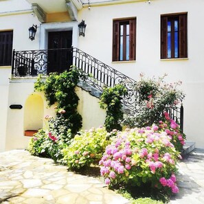 Traditional Mediterranean-style building with a charming courtyard and ornate balcony.