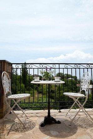Enjoy a peaceful moment in this serene outdoor seating area with a round table and two comfortable chairs.