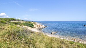 A coastal landscape with rocky terrain and vegetation.
