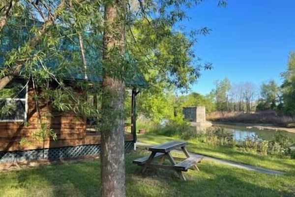 Cabin along side river with views of historic railroad pylon