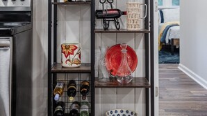 A kitchen with a wine rack holding several bottles, a decorative wreath, and a variety of kitchenware. - Ultimate Space for Your Family! ~ TIEC ~ Fire Pit+ (Landrum)