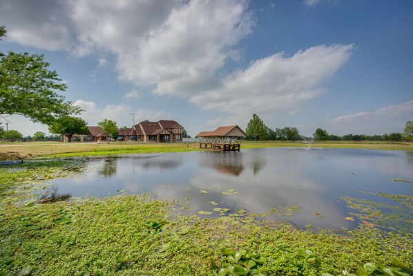 A serene lakeside setting with houses and a dock.