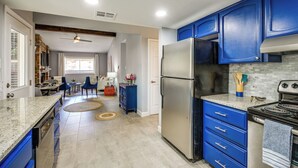 A modern kitchen with blue cabinets, a stainless steel refrigerator, and a gas stove. - Serene San Antonio Vacation Home w/ Smart TVs (San Antonio)