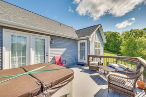 A covered deck with a pool table, outdoor furniture, and a view of a house with a garage and a covered porch. - Lake-view Kentucky Getaway w/ Resort Amenities! (Taylorsville)