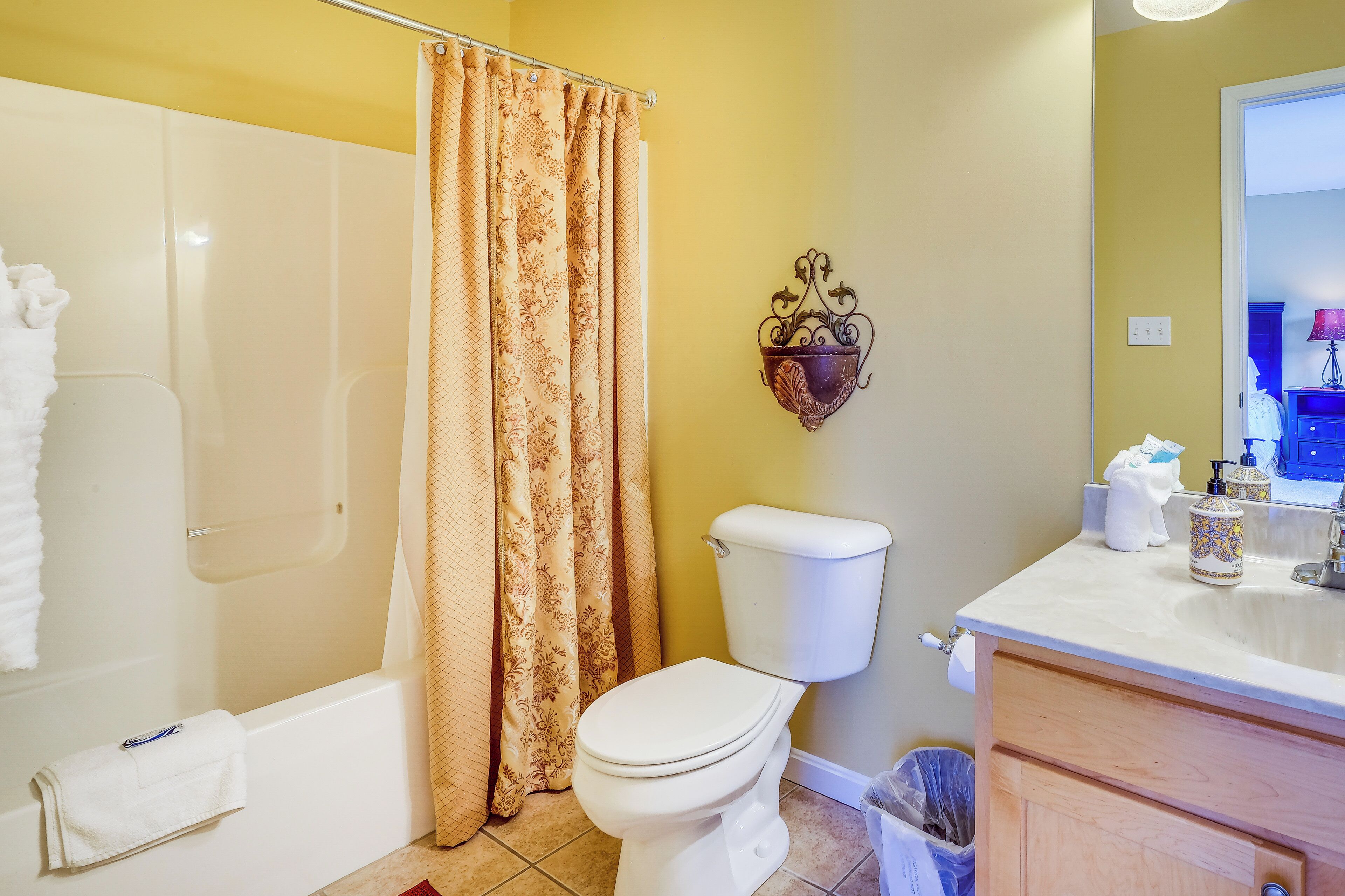 A bathroom with a bathtub, toilet, and sink.