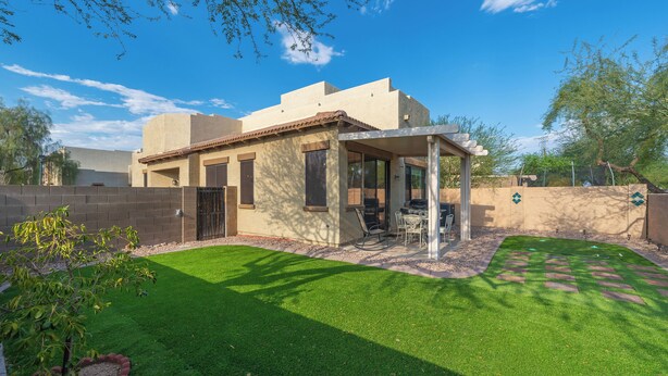 A house with a patio, a lawn, and a small tree. - Cozy Arizona Retreat w/ Patio, Grill & Pool Access (Mesa)
