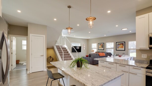 A modern kitchen with a central island, stainless steel appliances, and pendant lighting. - Spacious Minneapolis Vacation Rental w/ Game Room! (Minneapolis)
