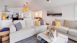 A modern living room with a sofa, coffee table, and decorative items. - East Jordan Vacation Rental on Lake Charlevoix! (East Jordan)