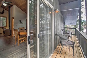Enjoy outdoor dining or relaxation on the spacious deck with a dining table and chairs.