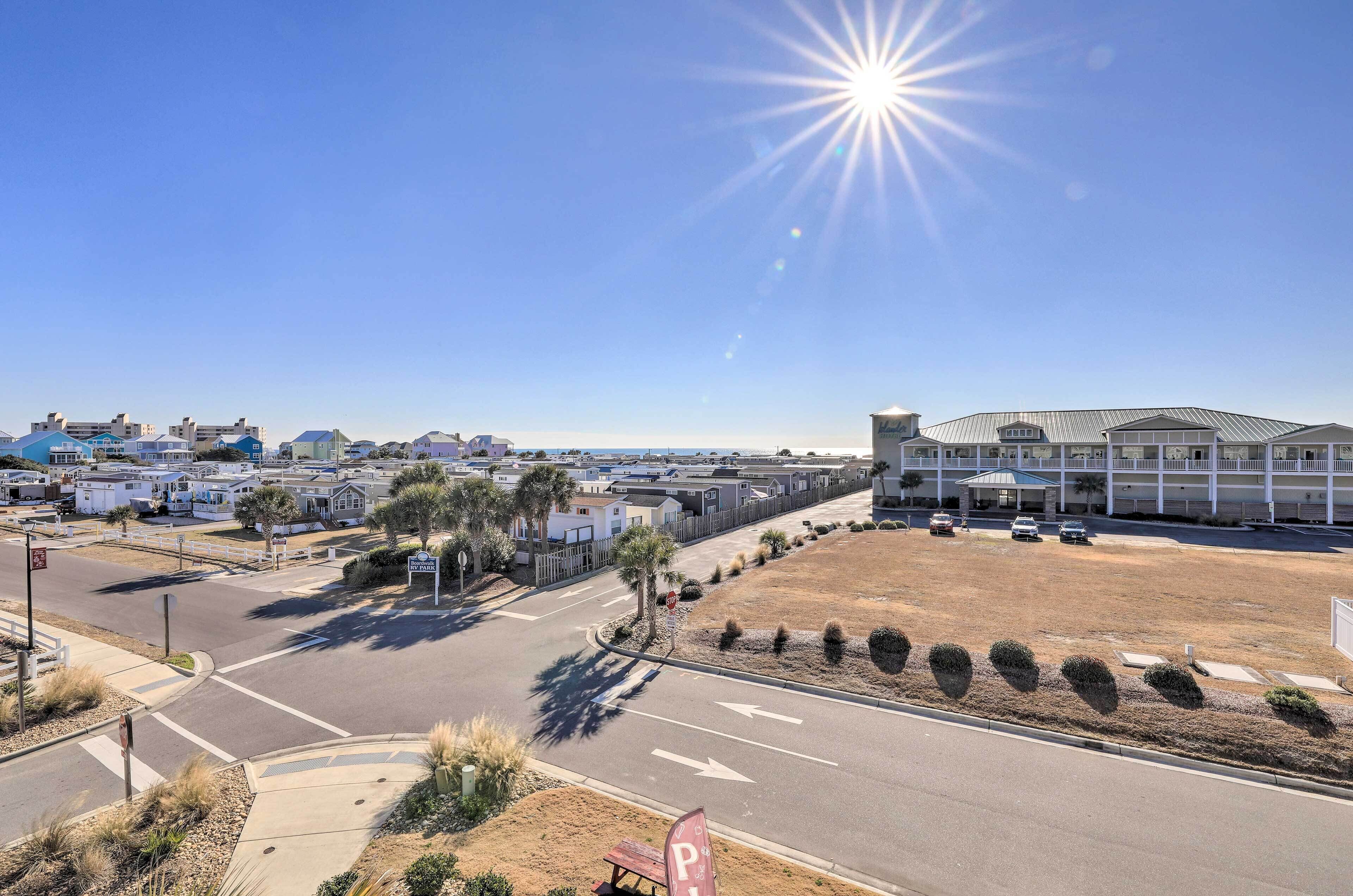 A parking lot with a clear sky and a building in the background.