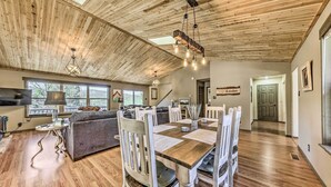 A spacious living area with a wooden ceiling, a dining table with chairs, and a sofa. - Ruidoso 'memories Mountain Retreat' w/ Hot Tub! (Ruidoso)