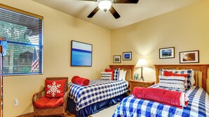 A hotel room with two beds, a chair, a ceiling fan, and a window with blinds. - Fireside Comfort & Family Fun: Wooded Show Low Gem (Show Low)