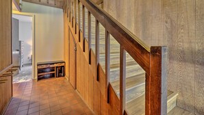 A wooden staircase with a handrail, leading to a landing with a small shelf and a door. - Ski & Soak: Hot Tub Haven in Tahoe City! (Tahoe City)