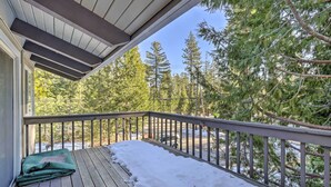 A wooden deck with snow on the ground, surrounded by trees. - Ski & Soak: Hot Tub Haven in Tahoe City! (Tahoe City)