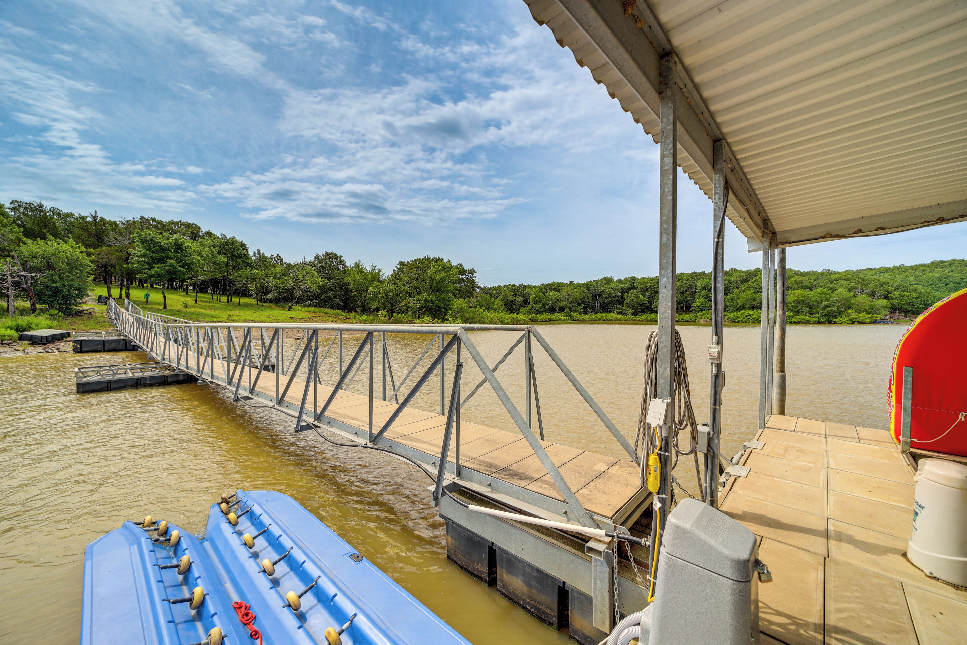 A bridge over water with a boat docked on the right.