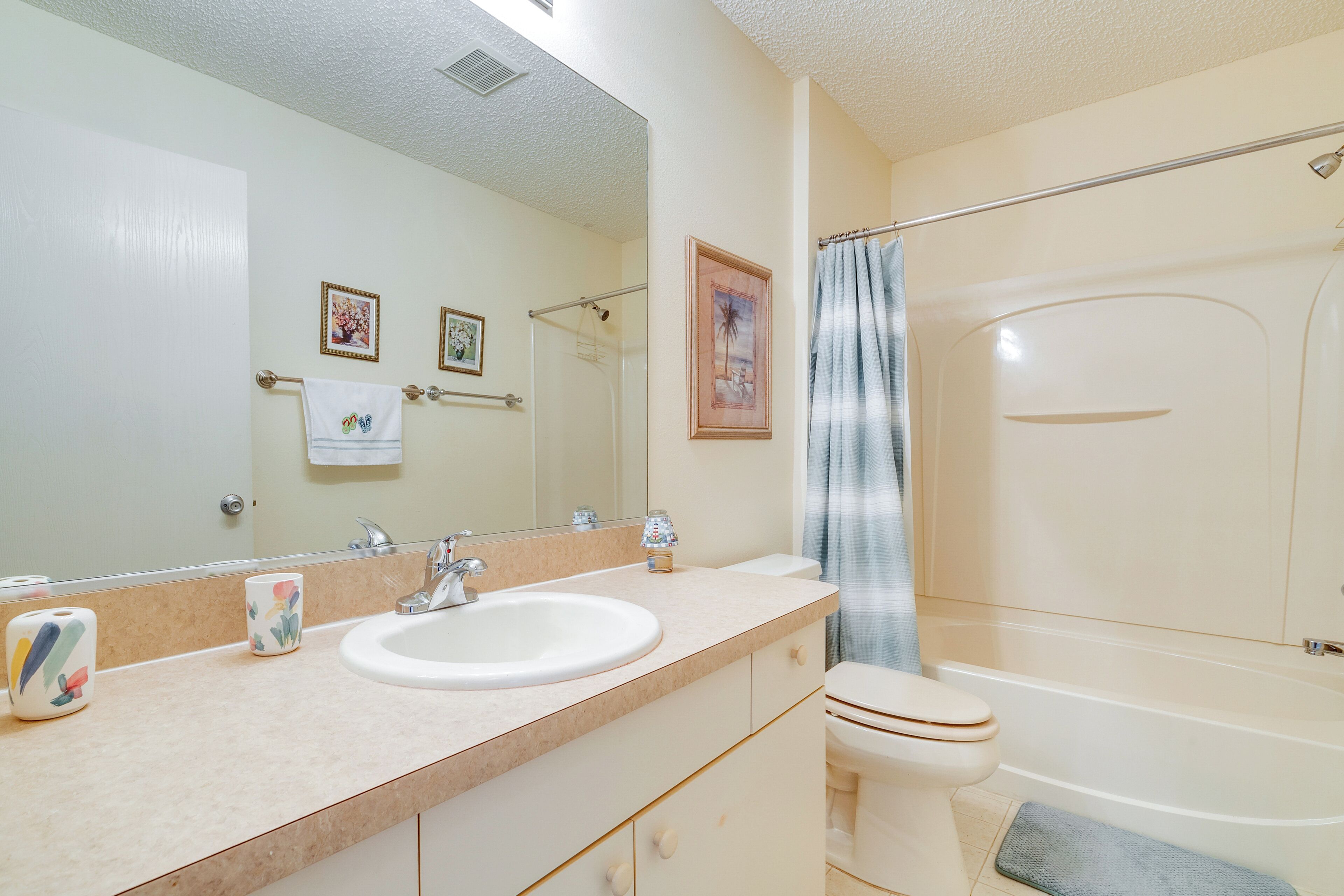 A bathroom with a sink, toilet, and bathtub.