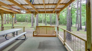 A covered picnic area with a bench, picnic table, and a view of a forest. - Hemphill Home w/ Community Perks < 1 Mi to Water! (Hemphill)