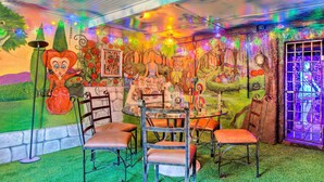 A room with a mural, a round table, and chairs. - Colorful Bisbee Home w/ Patio ~ 1 Mi to Dtwn! (Bisbee)