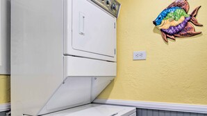 A laundry room with a white dryer and a colorful fish wall decoration. - Colorful Bisbee Home w/ Patio ~ 1 Mi to Dtwn! (Bisbee)