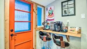 A kitchen with a wooden countertop, a coffee machine, and a bottle of water. - Colorful Bisbee Home w/ Patio ~ 1 Mi to Dtwn! (Bisbee)
