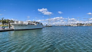 A marina with several boats docked, calm water, and a clear sky. - Cozy Cape Charles Apartment: Walk to Beaches! (Cape Charles)