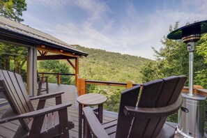 A wooden deck with outdoor furniture, a metal grill, and a view of a forested hillside. - Ski, Hike & Relax: Beech Mtn Gem w/ Sweeping Views (Banner Elk)