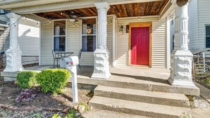 A white house with a red door, a porch with steps, and a mailbox. - Cozy Indianapolis Vacation Rental w/ Micro Farm! (Indianapolis)