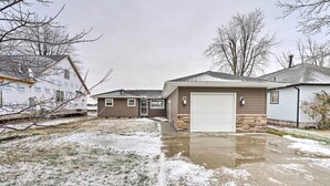 A residential area with houses, a garage, and a snow-covered lawn. - Waterfront East China Home w/ Dock & Patio! (East China)