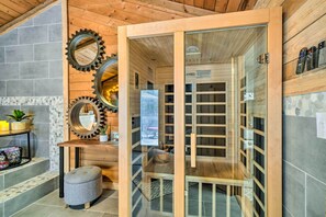 A sauna room with wooden benches, a glass door, and a mirror on the wall. - Peaceful Jamestown Retreat w/ Sauna! (Jamestown)