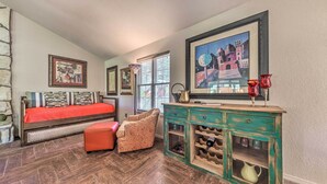 A bedroom with a bed, a chair, a dresser, and a window. - Ruidoso Getaway w/ Deck, Golf Course Views! (Ruidoso)