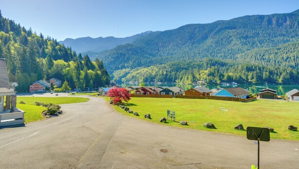 Área residencial com casas, uma estrada bem definida e um lago ao fundo.