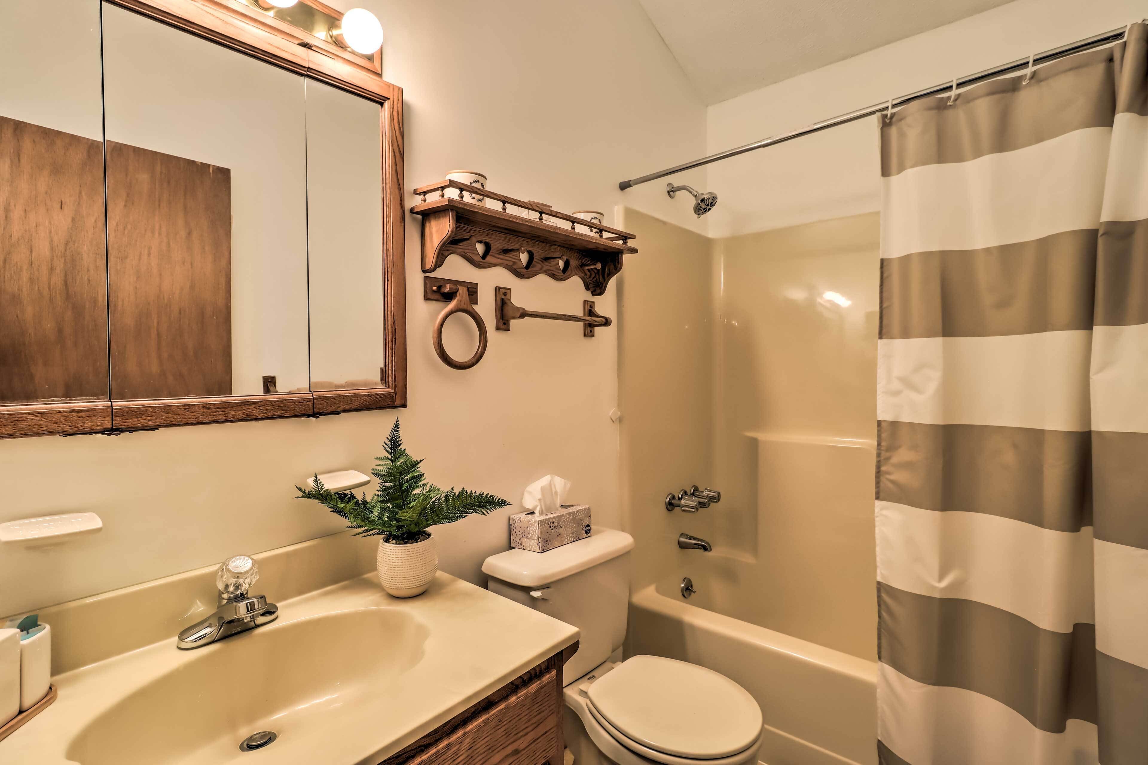 A bathroom with a sink, toilet, and bathtub.