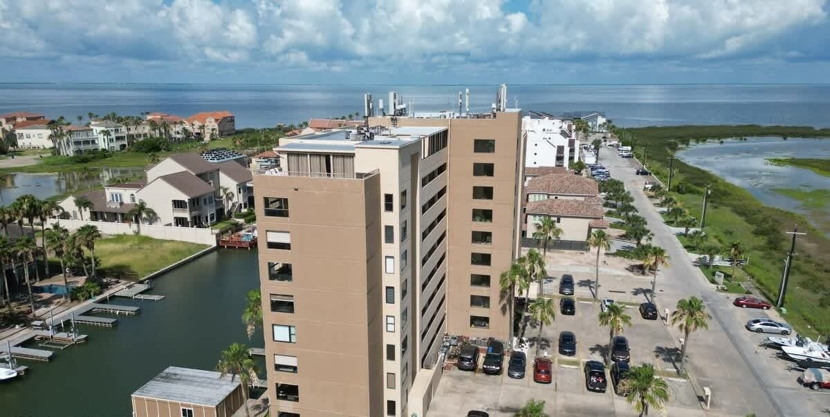 A coastal hotel with multiple buildings, a marina, and a parking lot.