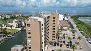 A coastal hotel with multiple buildings, a marina, and a parking lot.