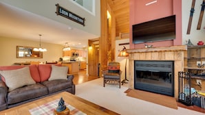 A spacious living room with a fireplace, a sofa, and a coffee table.