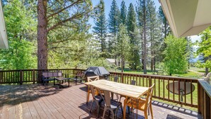 A wooden deck with a table and chairs, surrounded by trees and a grill. - Calpine Mountain Retreat w/ High-speed Internet (Calpine)