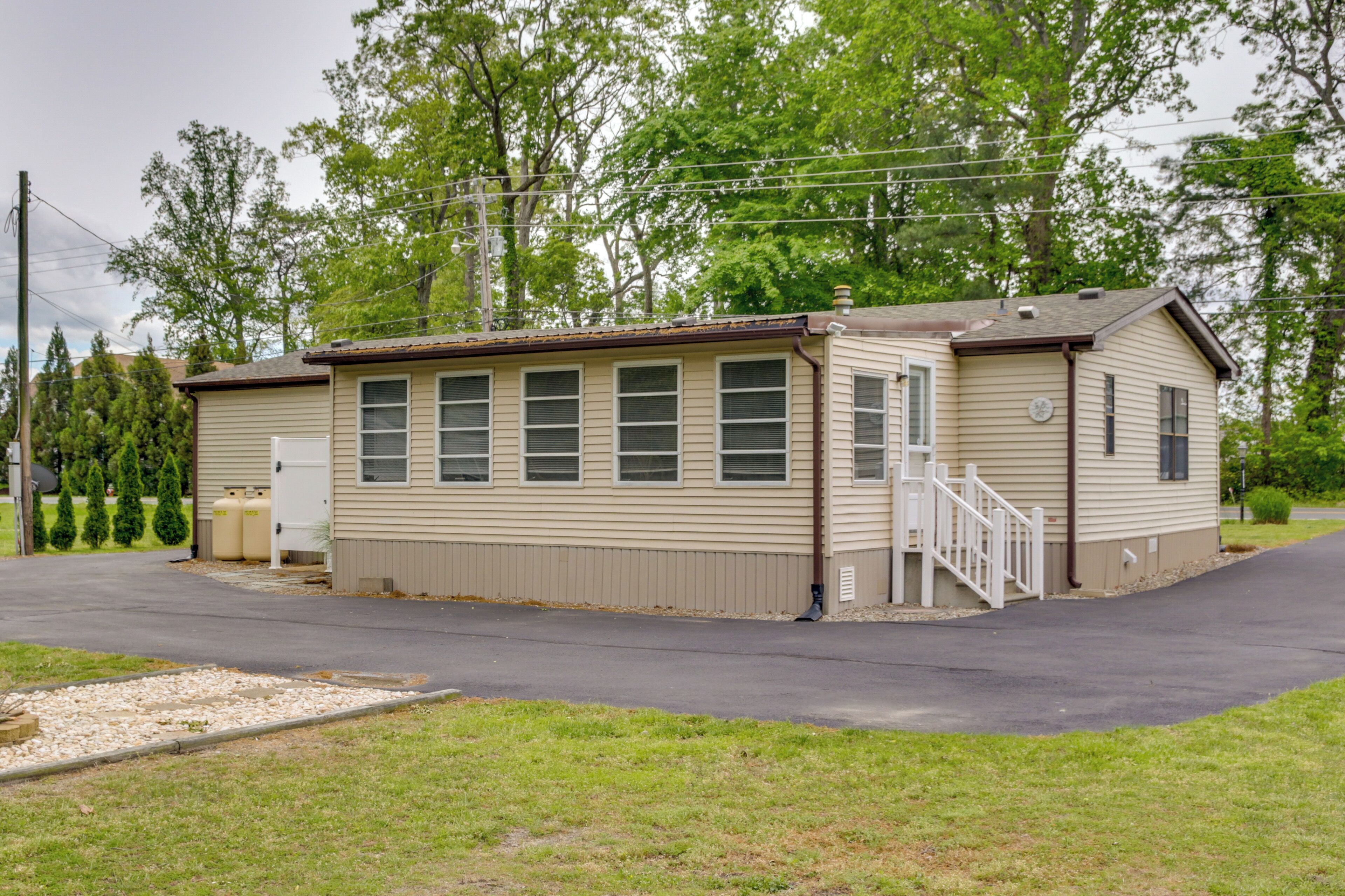 A single-story mobile home with a front porch and a small attached garage.