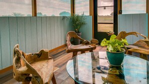 A room with wooden furniture, a glass table, and a view through a door. - Raymondville Apartment w/ Patio: Near Lakes! (Raymondville)