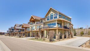 A modern multi-story residential building with balconies, large windows, and a stone foundation. - Fraser Getaway w/ Deck Near Winter Park Resort! (Fraser)