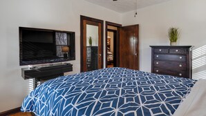 A bedroom with a bed, a TV, a dresser, and a ceiling fan. - Idyllic Home Near Indianapolis Motor Speedway (Indianapolis)