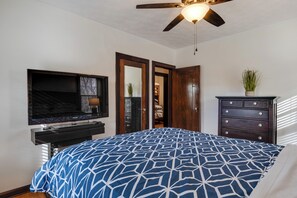 A bedroom with a bed, a TV, a dresser, and a ceiling fan. - Idyllic Home Near Indianapolis Motor Speedway (Indianapolis)