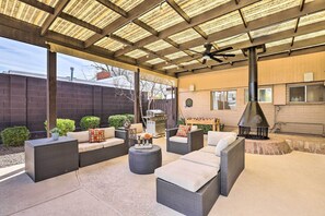 An outdoor patio with wicker furniture, a grill, and a chimney. - 7 Mi to Downtown Phoenix: Home w/ Pool & Foosball! (Phoenix)