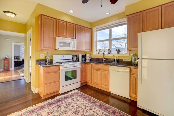 A kitchen with wooden cabinets, a microwave, stove, and dishwasher. - Canal-front Gem! 25 Mi to Saratoga Springs & Track (Waterford)