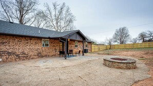 A brick house with a patio, outdoor seating, and a stone fire pit. - Chandler Vacation Rental on Route 66, Near Casino (Chandler)