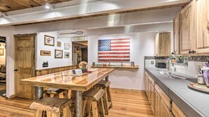 A rustic kitchen with wooden furniture, a large American flag, and a wooden ceiling. - 8 Mi to Heavenly Mtn Resort! Hot Tub Hideaway (South Lake Tahoe)